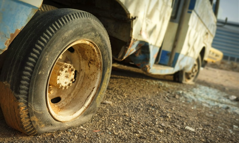 Car with a flat tire pulled over on the side of the road